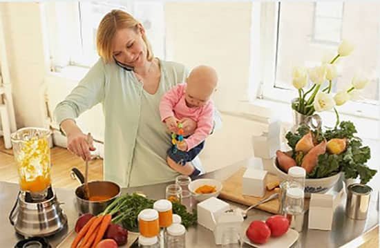 mother preparing baby food in a baby food processor for her baby